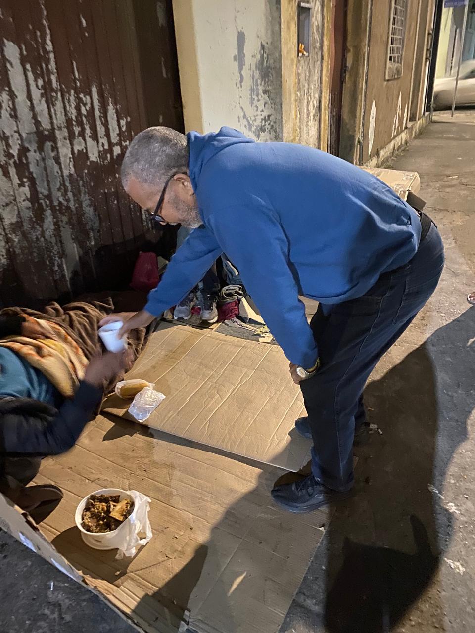 Voluntários do Grupo Visíveis para Cristo distribuindo lanches ao povo de rua em Paranaguá